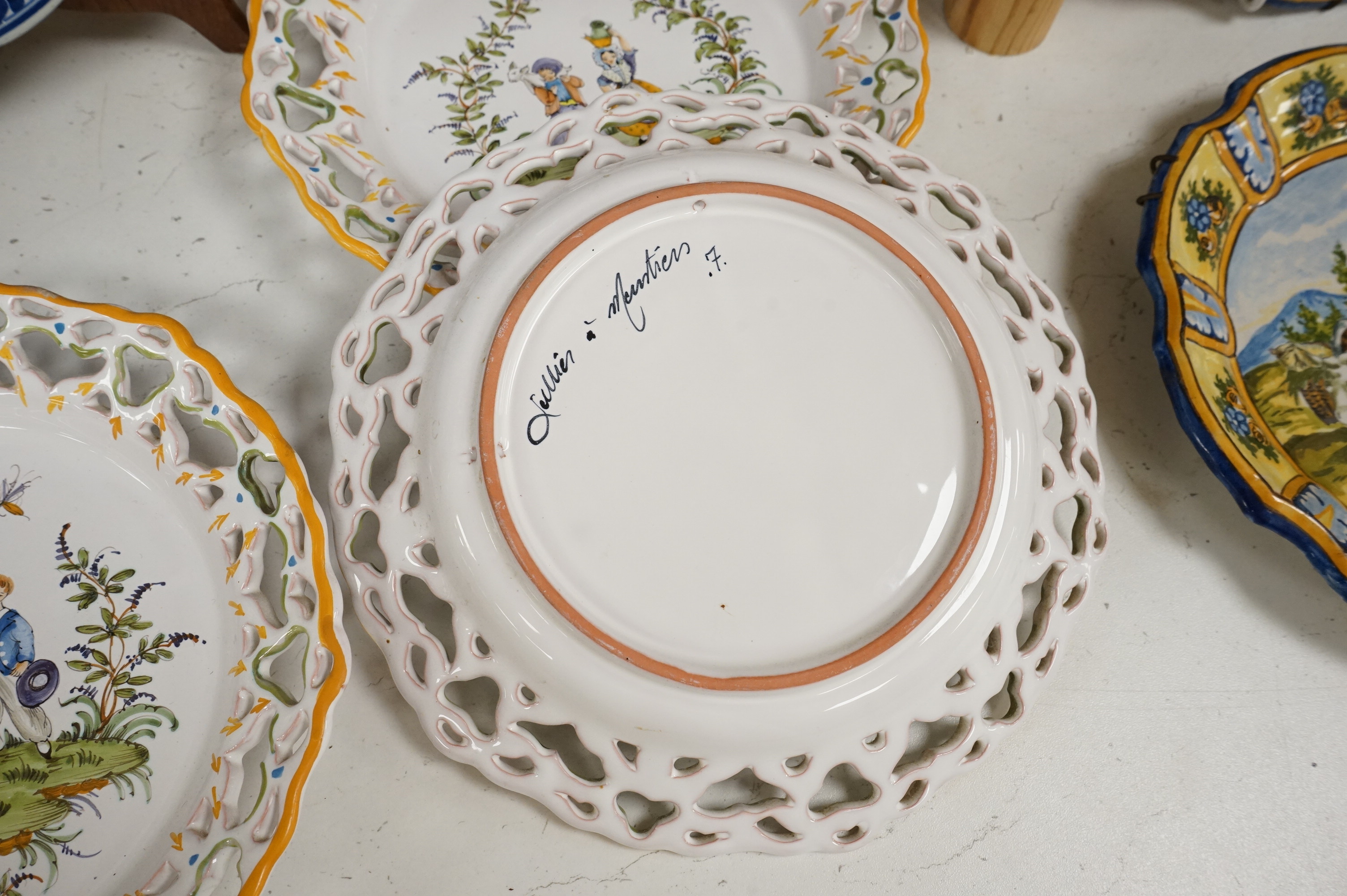 A Delft charger after Artz, together with other faience and majolica dishes, largest 41cm diameter (6)